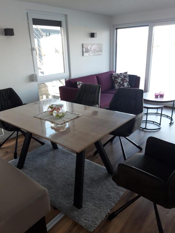 a living room with a table and a couch at Hausboot MeerZeit in Wangerland