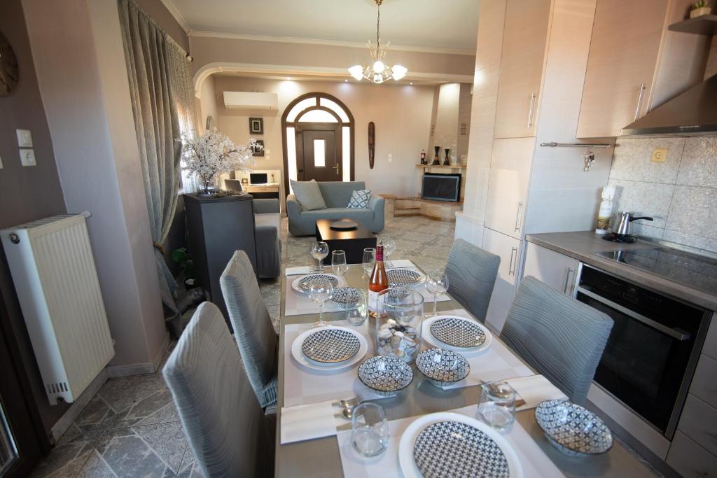 a kitchen with a table with glasses on it at Sunrise Suite Olympiada - Luxury Beachfront Escape in Olympiada