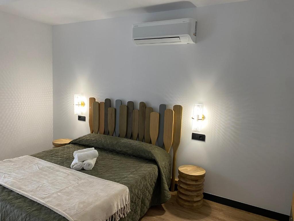 Un dormitorio con una cama con un cabecero grande de madera. en Casa Cancela, en Palas de Rei 