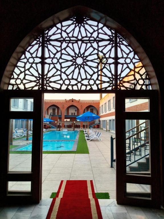 a view of a swimming pool through an archway at Dahab Now in Dahab