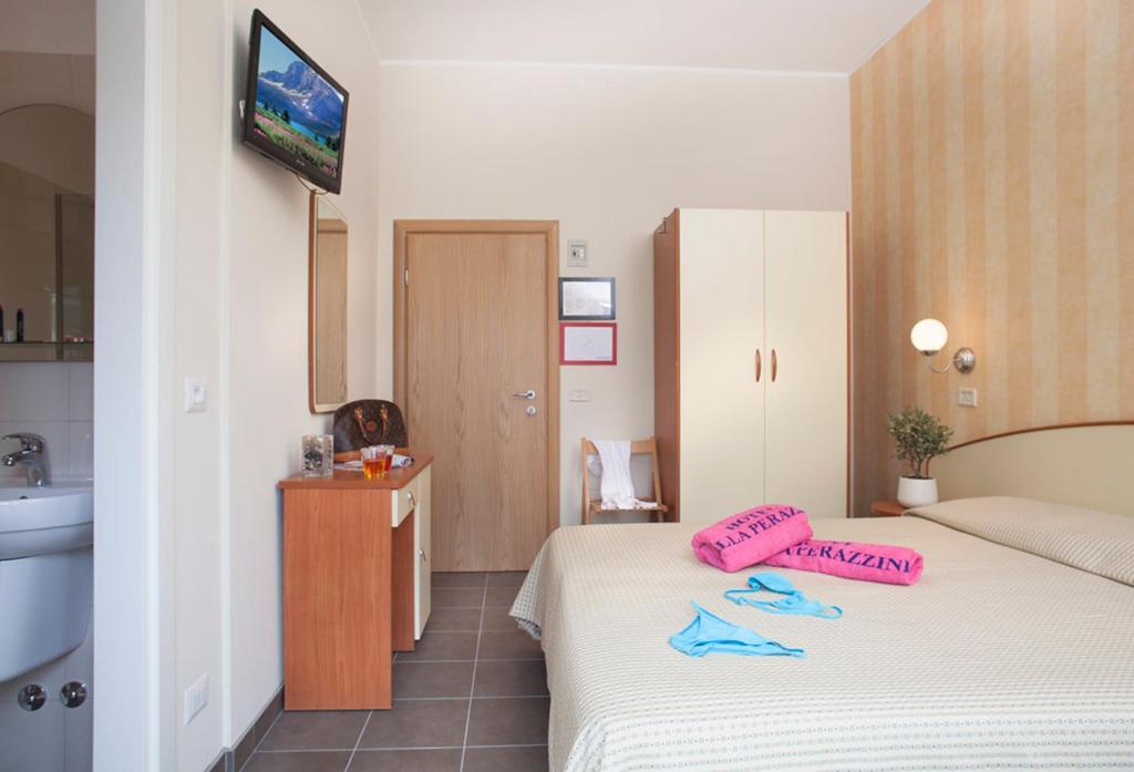 Postel nebo postele na pokoji v ubytování Hotel Villa Perazzini