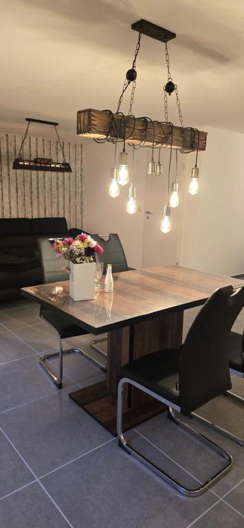 a dining room with a large wooden table and chairs at The Rose in Rheinhausen