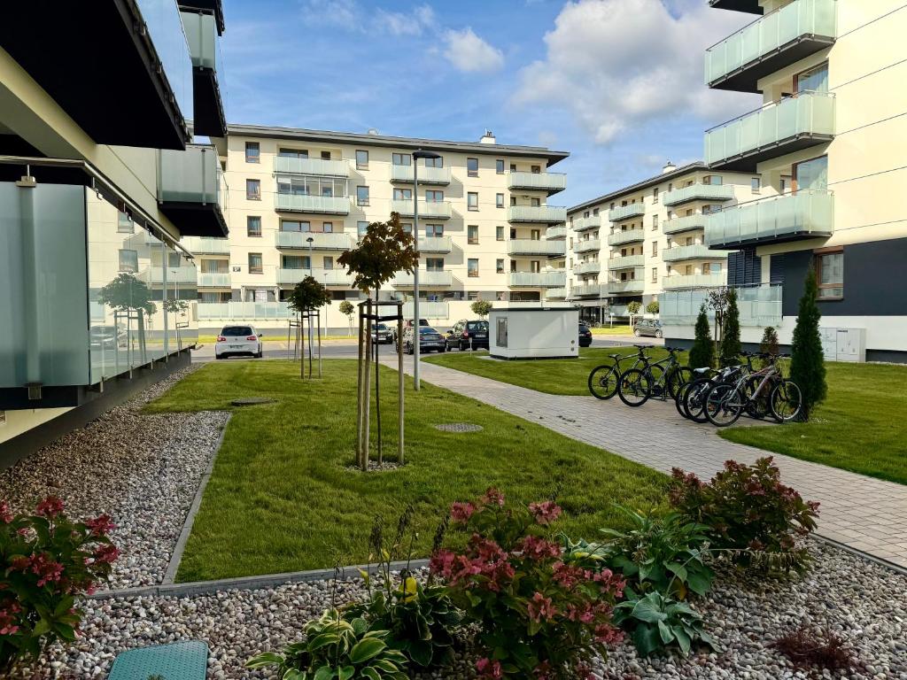 a park with bikes parked next to a building at Apartament Osiedle Piano Park Suwałki in Suwałki