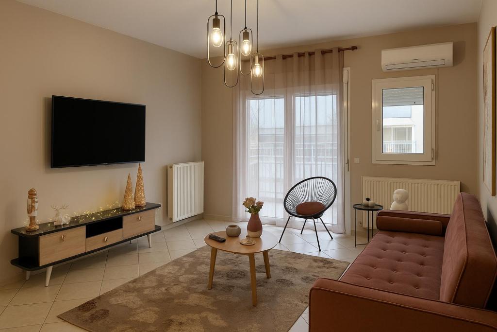 a living room with a couch and a tv at Dream House by Lifehouses at Katerini in Katerini