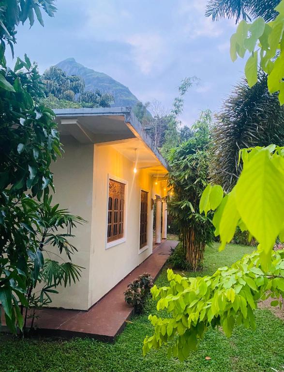 a house with a pathway leading to the front yard at DropHaus in Naula