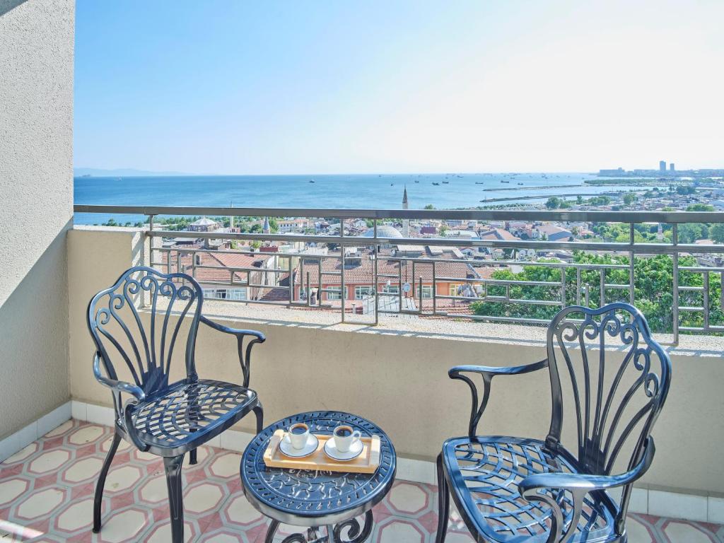 two chairs and a table on a balcony with a view at Four-G Hotel in Istanbul