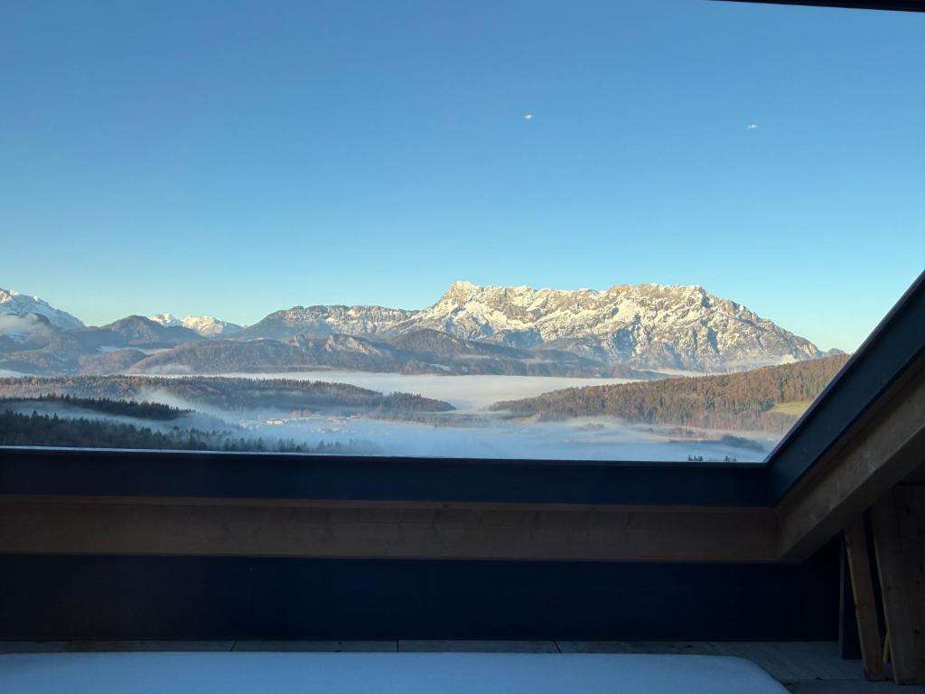 a view of a mountain range from a window at Apartment Sonnenberg in Hallein