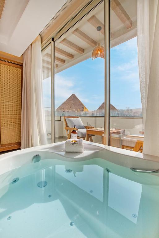 a hot tub in a room with a view at ONE GATE Pyramids View INN in Cairo