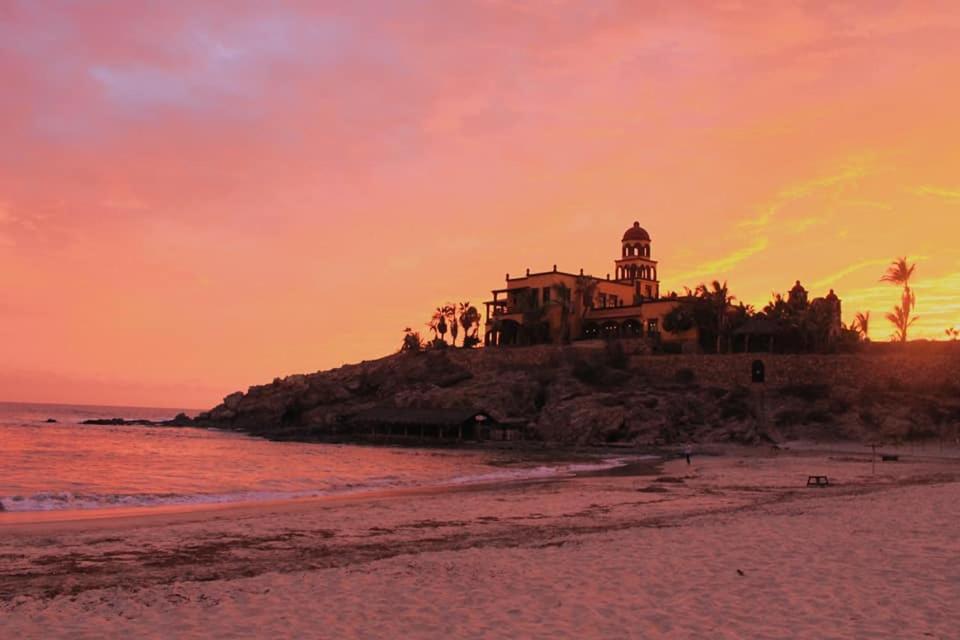 a house on an island in the ocean at sunset at Luxury Oceanfront Trailer Home Cerritos in San Carlos