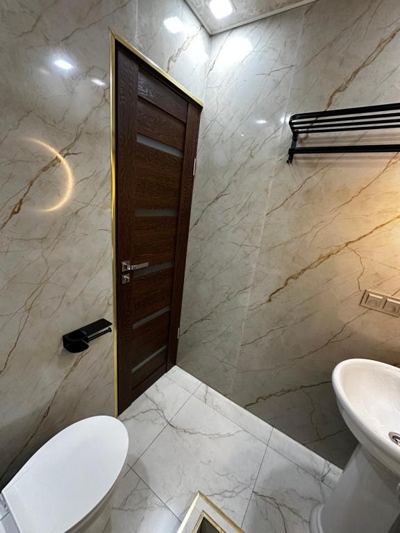 a bathroom with a toilet and a sink at Americana By California in Yerevan