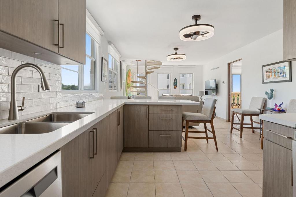 a kitchen with a sink and a counter at Costa Ensenada Penthouse 505 across the street from Balneario beach in Rincon