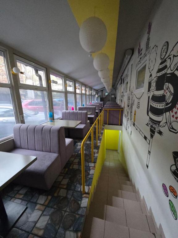a room with couches and tables in a restaurant at The Hostel in Kyiv