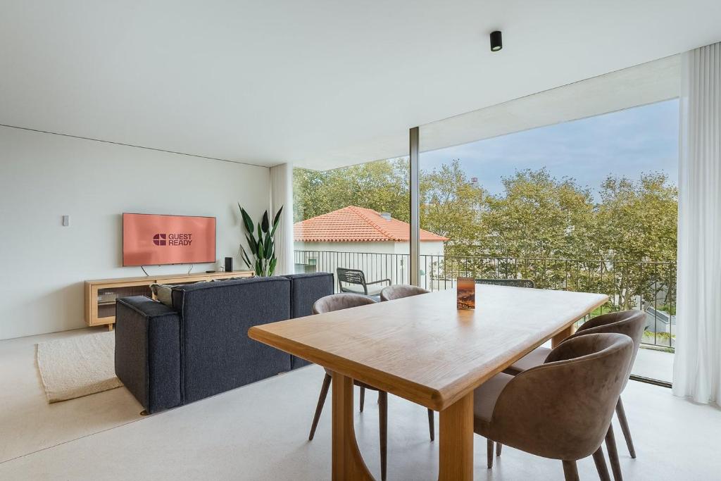 ein Esszimmer mit einem Holztisch und Stühlen in der Unterkunft GuestReady - DPV Residences in Porto