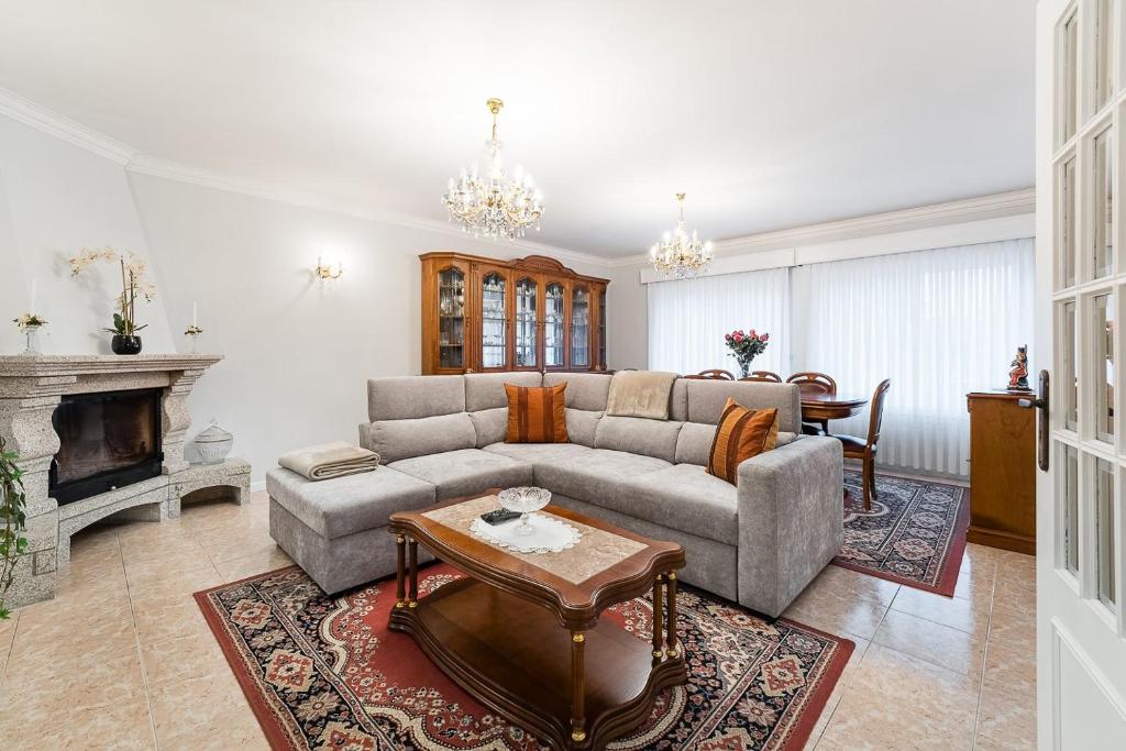 a living room with a couch and a table at GuestReady - Urban rustic in Esposende in Esposende