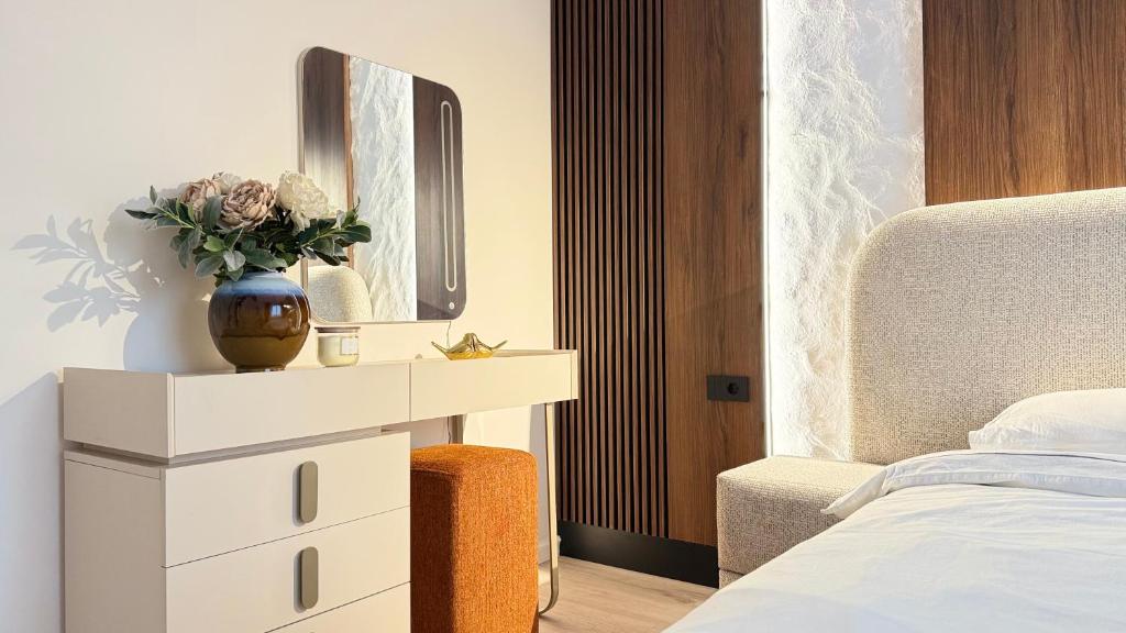 a bedroom with a white dresser and a mirror at Vanilla Studio Apartment 2 in Timişoara