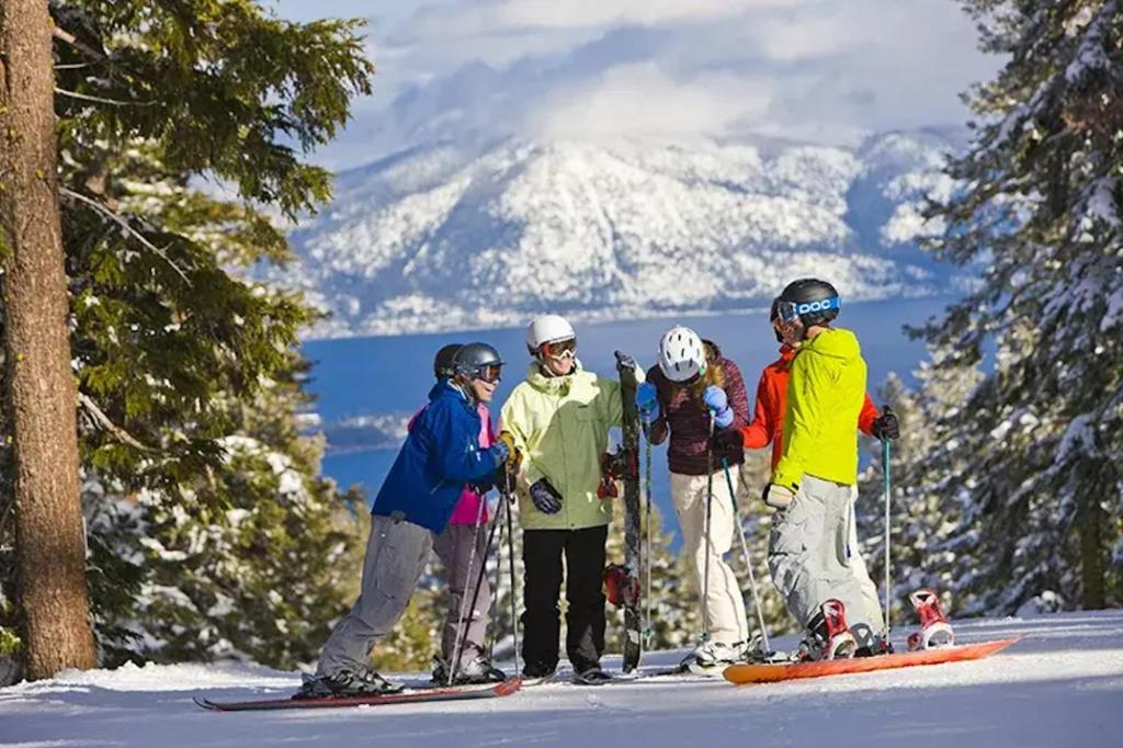 a group of people standing on top of a snow covered mountain at Lakeside Condo Close to Slopes Excellent Location in Tahoe Vista