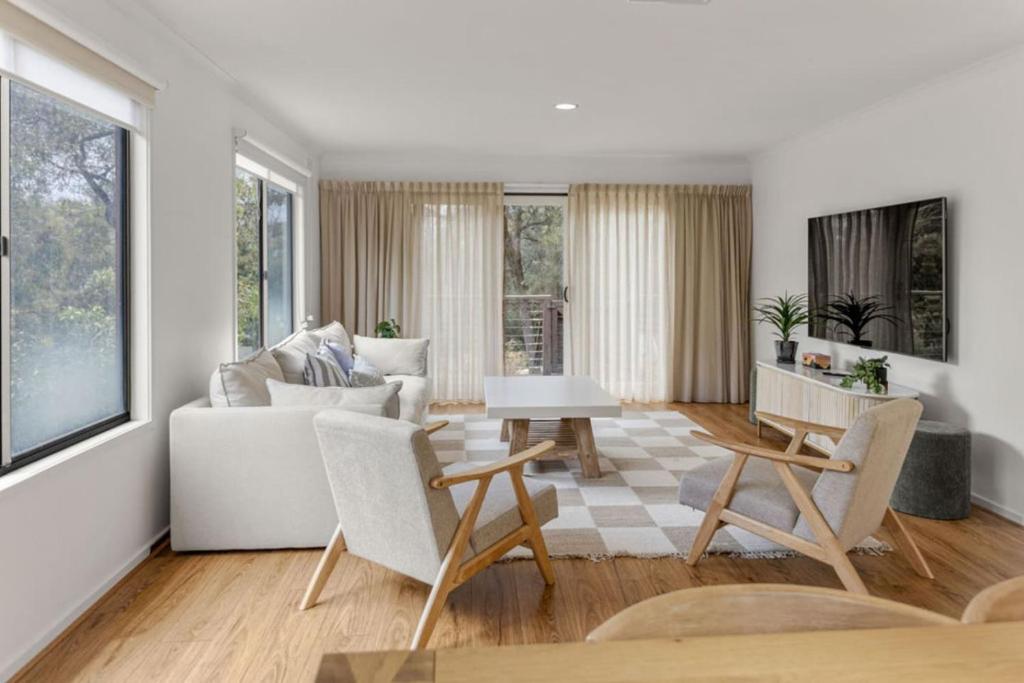 a living room with a couch and a table at Saltwater Shack in Anglesea