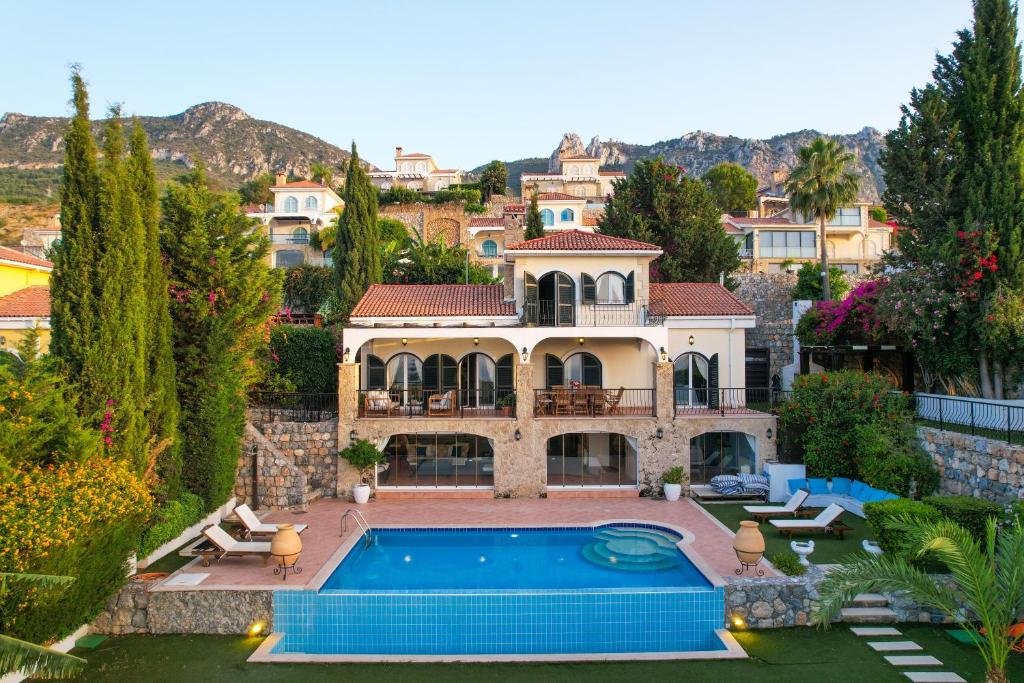 a house with a swimming pool in a yard at Villa Ambiance in Kyrenia