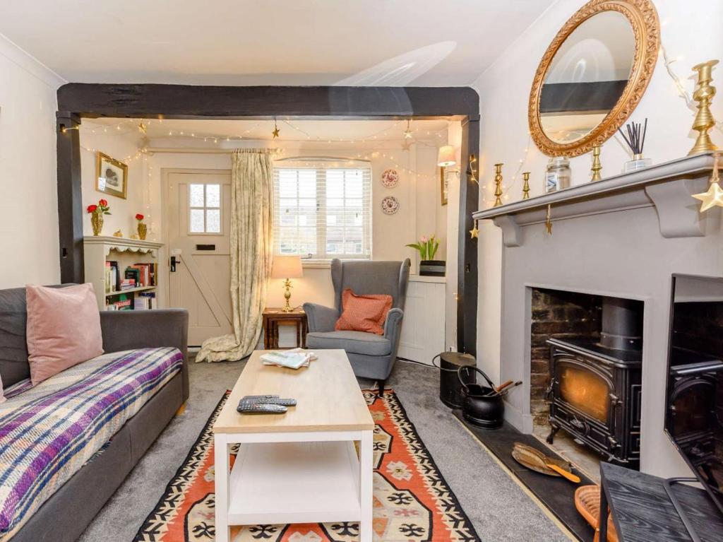 a living room with a couch and a fireplace at 1 Bed in Tenterden oc-66342 in Tenterden