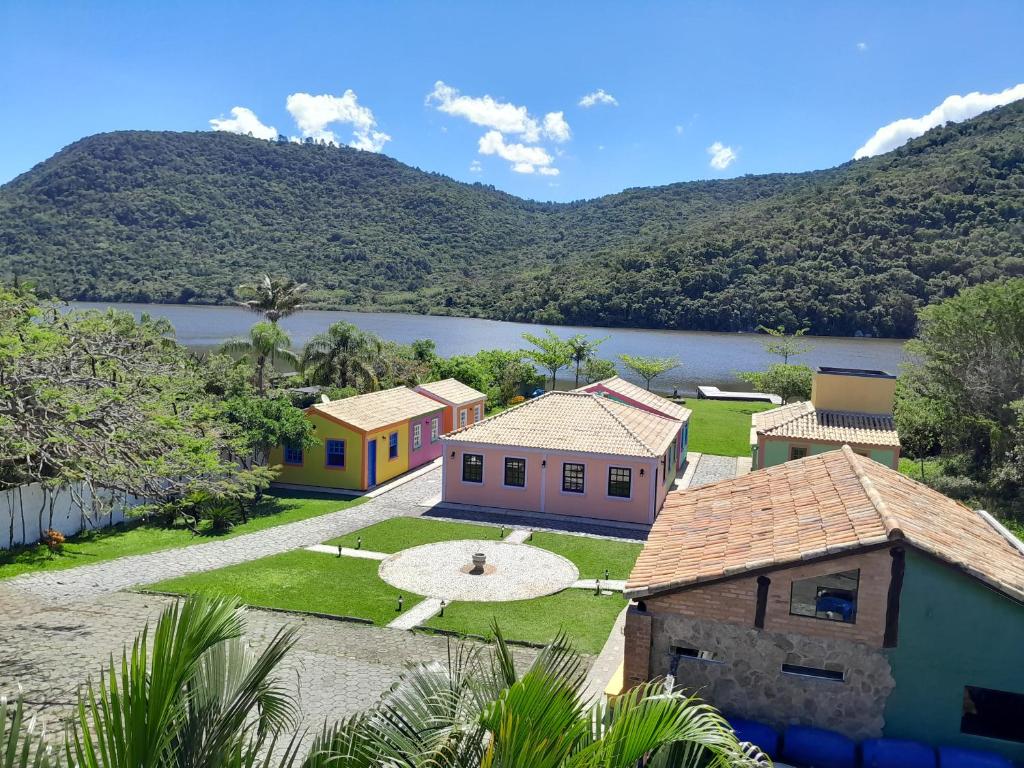 a group of houses with a lake in the background at Recanto dos Açores in Florianópolis