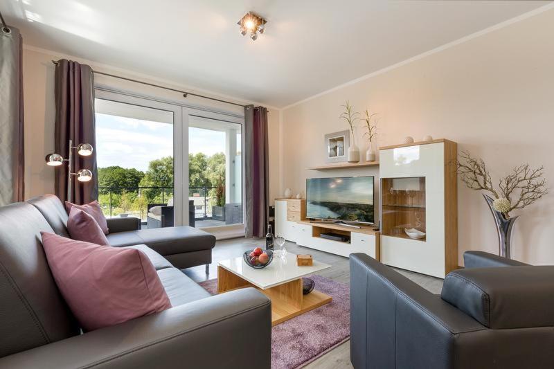 TV a/nebo společenská místnost v ubytování Residenz Seeterrassen Appartment Nr. 1