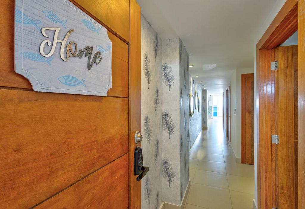 a hallway with a home sign on a door at Las Olas, Juan Dolio 2bed2bath Condo in Guayacanes