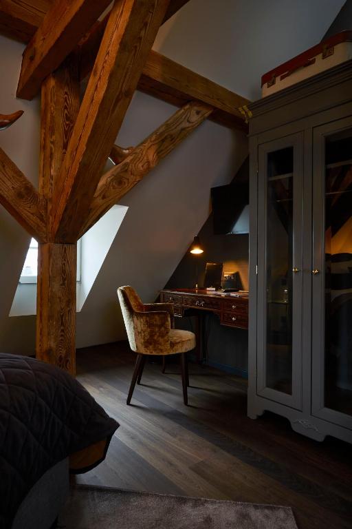 an attic room with a desk and a chair at Boutique Hotel Spedition a member of DESIGN HOTELS in Thun
