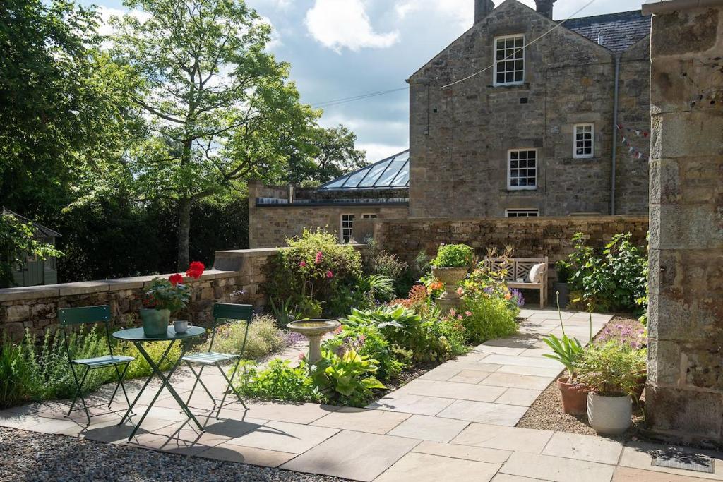 a garden in front of an old stone building at Little Birks in Bellingham
