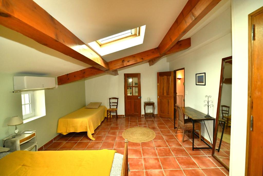 a room with a bed and a table in a room at Les Mourguettes in La Celle-sous-Gouzon