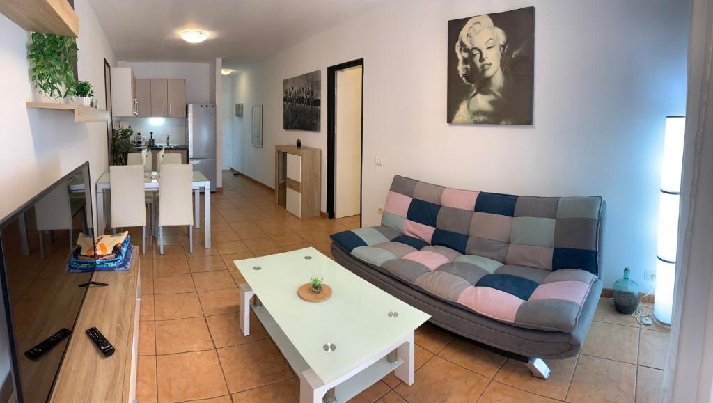 a living room with a couch and a table at Vista de Torre in Costa Del Silencio