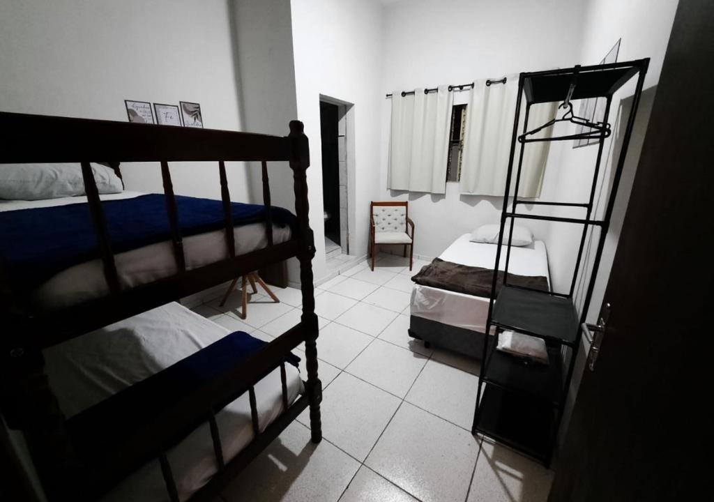 a bedroom with two bunk beds and a ladder at Pousada Villa in Piquete