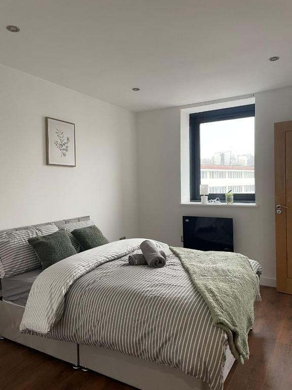a white bedroom with a bed and a window at Nottingham Central Accommodation in Nottingham