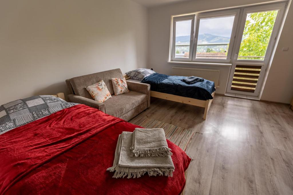 a bedroom with a bed and a couch and a window at Agroturystyka Na górce in Węgierska Górka