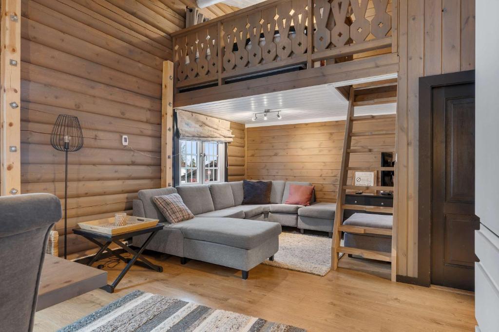 a living room with a couch and a loft bed at Vikinggrenda 16A by Vacation Trysil in Trysil