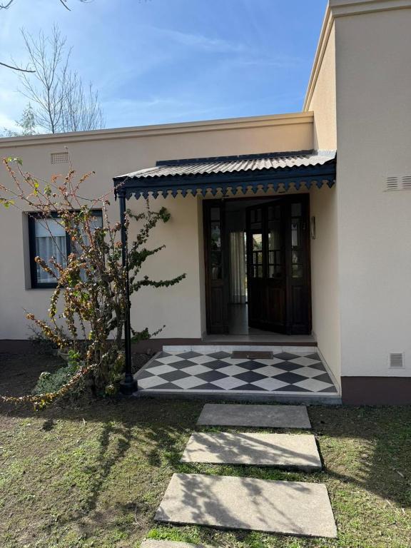 a house with a black and white checkered floor at Barrio Privado - YB - Tucumán in Yerba Buena