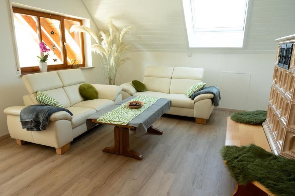 a living room with a couch and a table at Ferienwohnung Familie Löffler in Ostrach