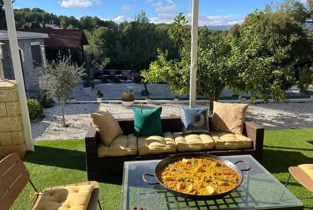 a pizza sitting on a table on a patio at Villa Jazmín - Piscina - BBQ - Jardín - Chill out in Masía Aldamar