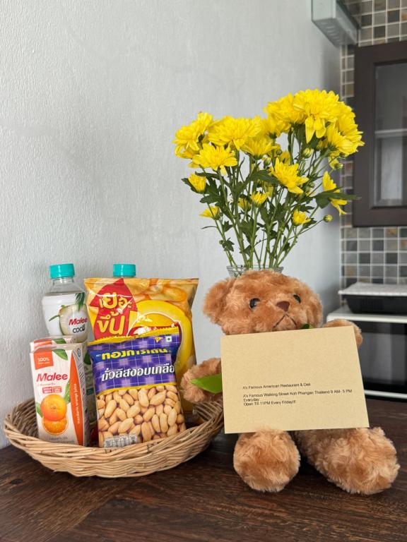 a teddy bear sitting next to a basket of food at Ocean View Mini-Villa in Wok Tum