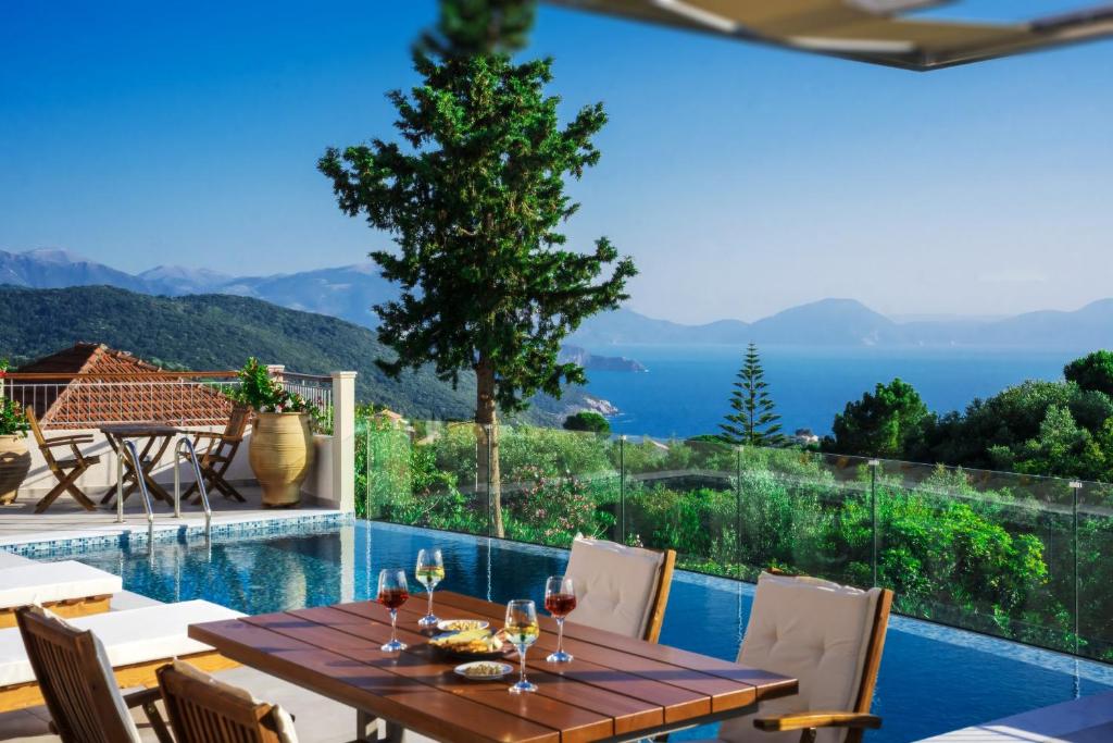 a dining room with a table and a view of the ocean at Pithari Stone Villa in Khalikerí
