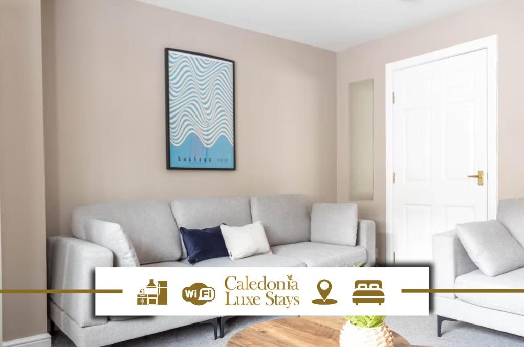 a living room with a couch and a table at Colinsburgh House in Colinsburgh