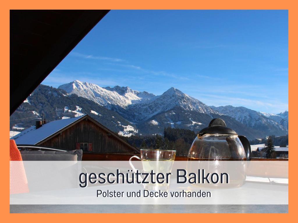 a sign that reads psychiatrist ballion with mountains in the background at Biohof Burger, 3 sonnige Fewo, alle mit Balkon, Spielzimmer, Grillhütte, 7 km vor Oberstdorf in Bolsterlang