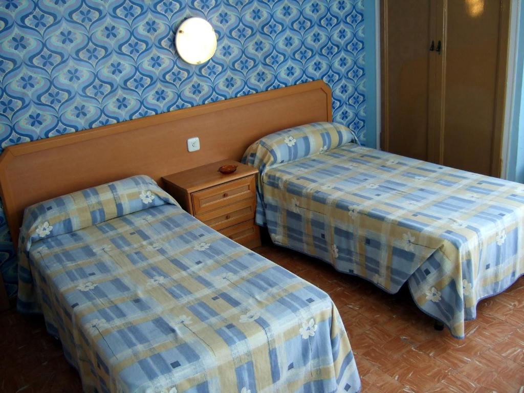 Postel nebo postele na pokoji v ubytování Hostal Julieta