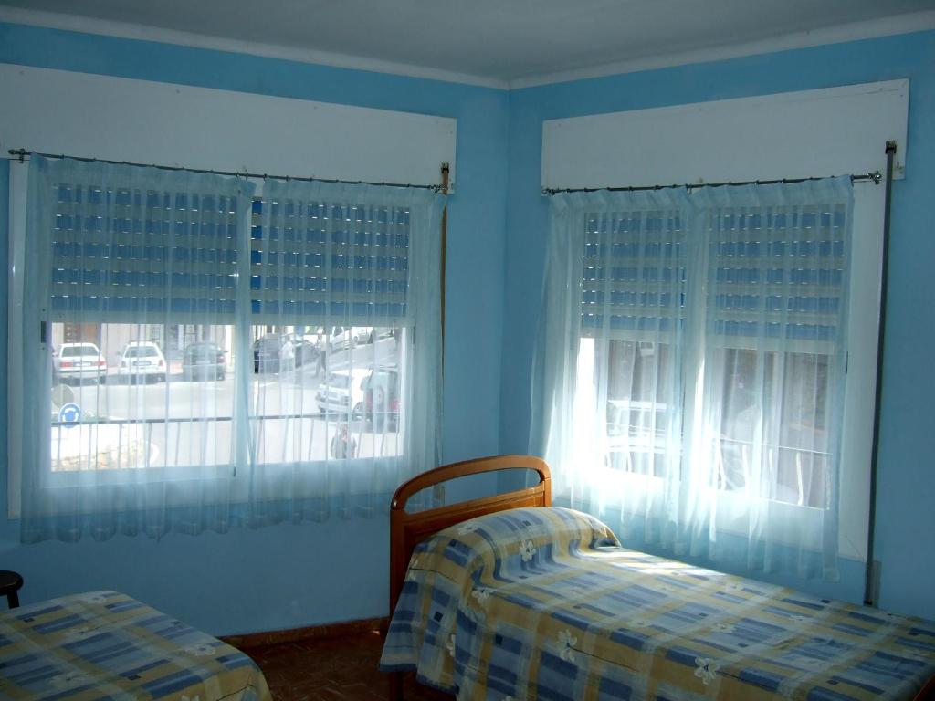 Postel nebo postele na pokoji v ubytování Hostal Julieta