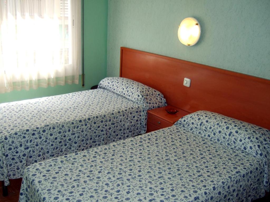 Postel nebo postele na pokoji v ubytování Hostal Julieta