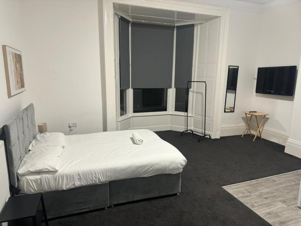 a bedroom with a bed and a table in it at Park Studios in Sunderland