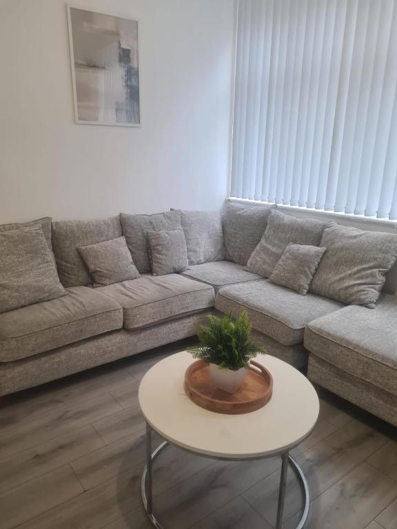 a living room with a couch and a table at Pudding Chare Apartments in Newcastle upon Tyne