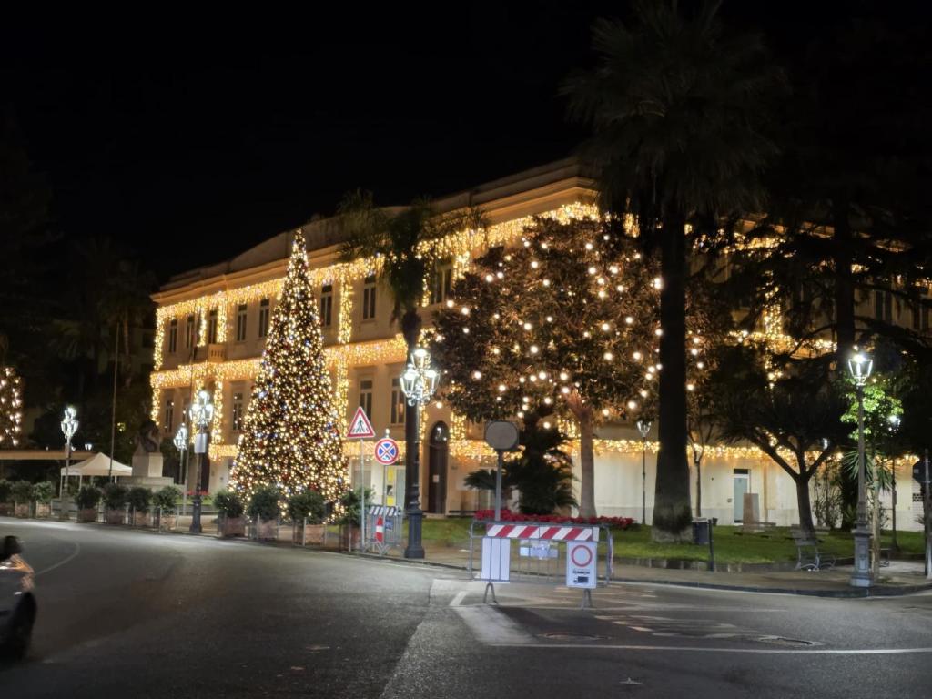 a building decorated with christmas trees and lights at La Casa di Teo Sorrento Coast in Sant'Agnello