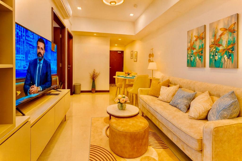 a living room with a couch and a tv at Trizen Colombo stylish high rise condo -Vistablu 32 in Colombo