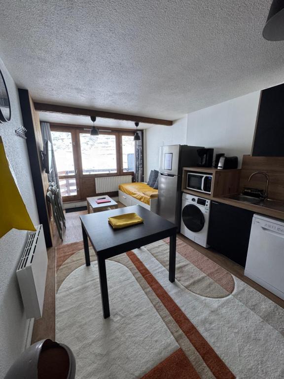 a small kitchen with a table in a room at Appartements pied des pistes - Résidence Mongie - Tourmalet in La Mongie
