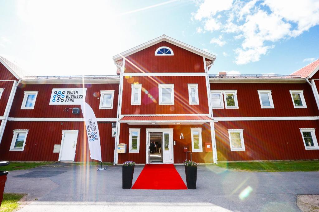 a red building with a red carpet in front of it at Boden Business Park in Boden